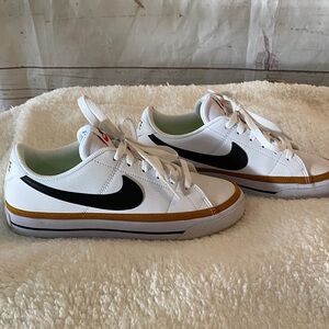 Women’s Nike - White and Black Sneakers with Gold Accents